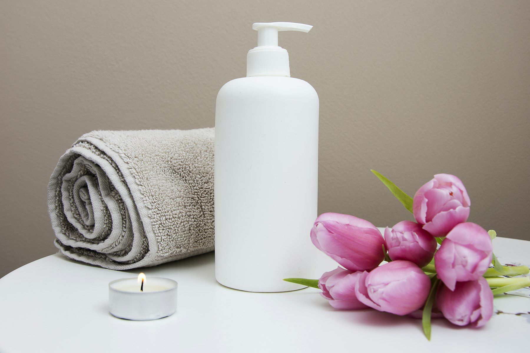 Towel, skincare products and a candle in the studio